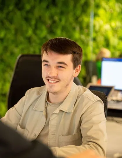 A member of the Kabinly team at the office green wall
